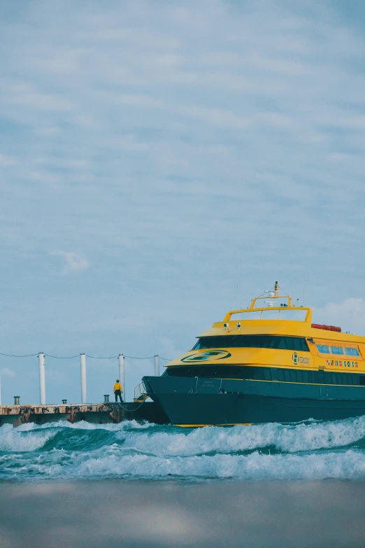 a yellow and green boat on the water