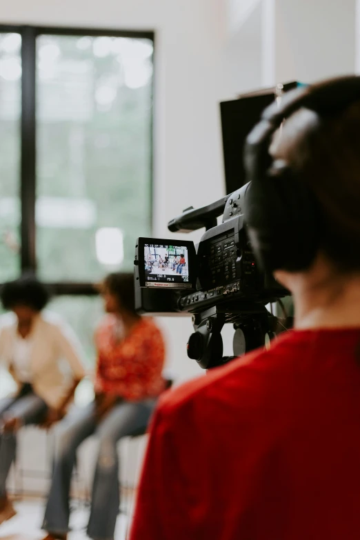 a camera recording a woman using a video set