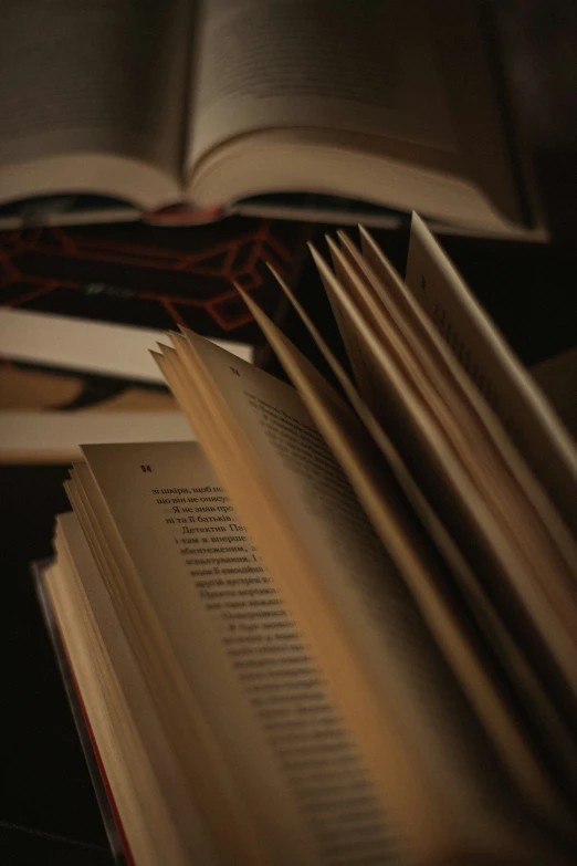 a stack of books sitting on top of a wooden table