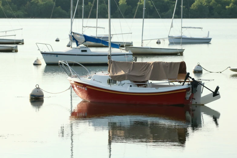 a boat is docked on the water in front of other boats