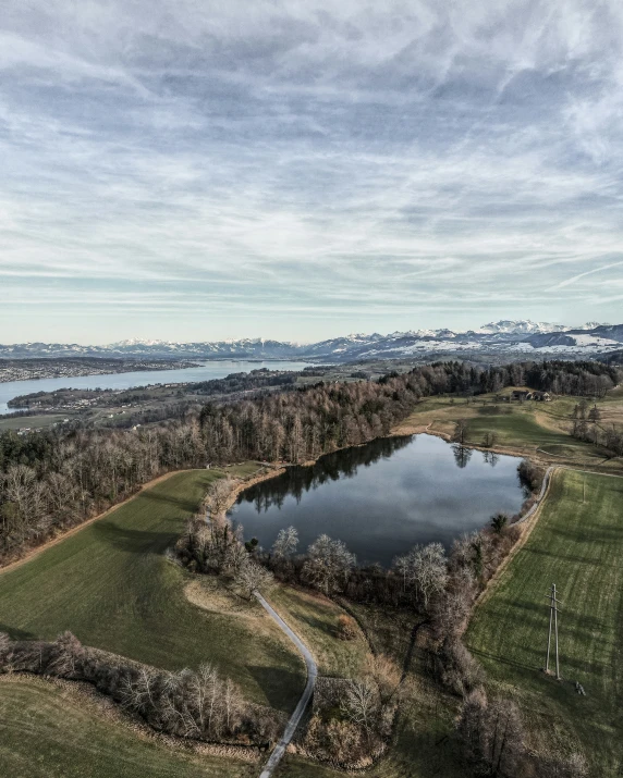 aerial po of an open field and lake