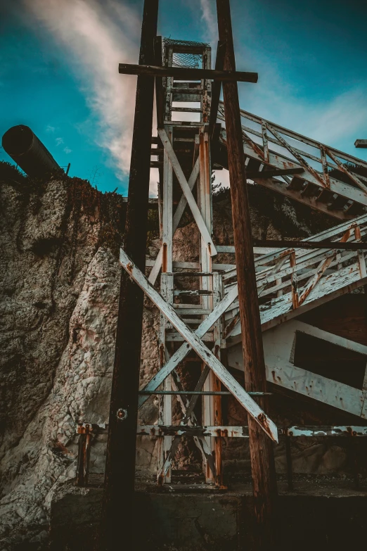 an old, rusty wooden water tank tower with stairs going into it