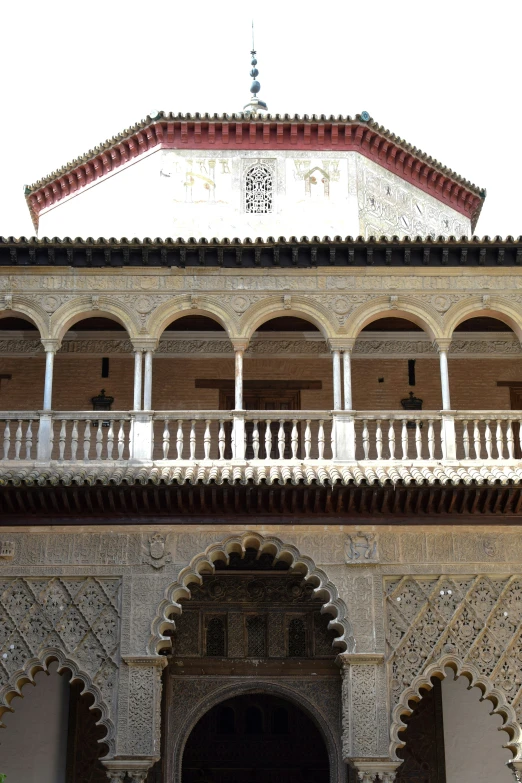 an intricately decorated courtyard under a white and tan building