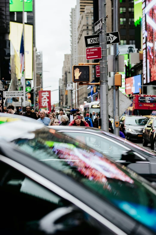 a busy street filled with cars and lots of people