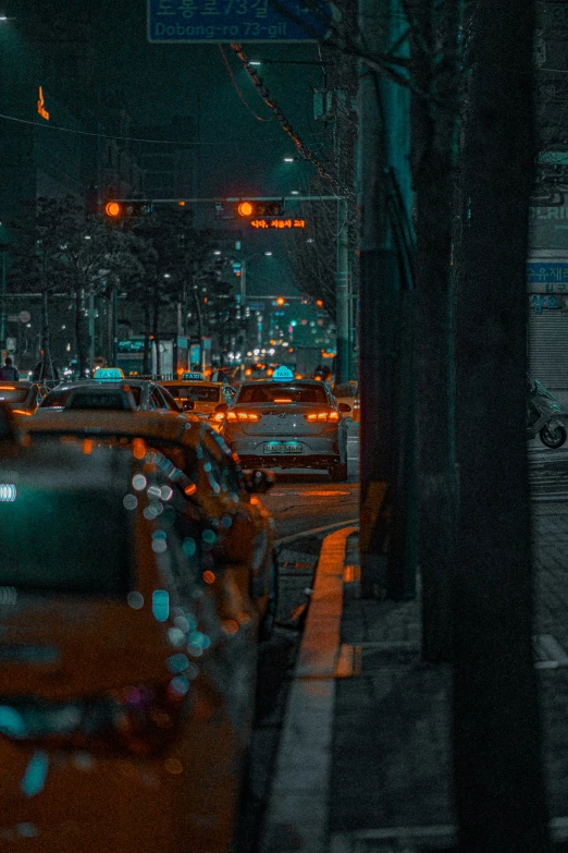 cars parked on the side of the road at night