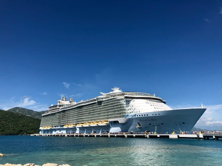 large cruise ship docked with pier on it