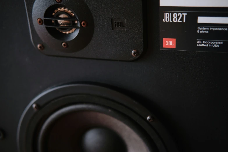 a close up of speakers with some red and white labels