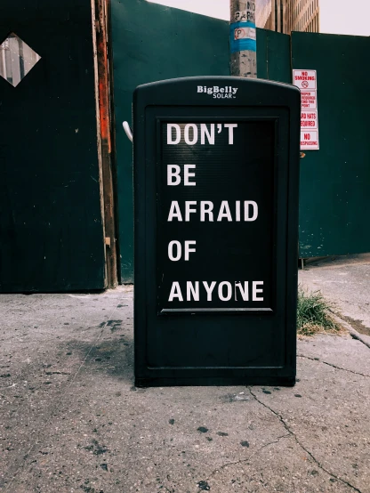 a sign that says don't be afraid of anyone is written on the side of a building