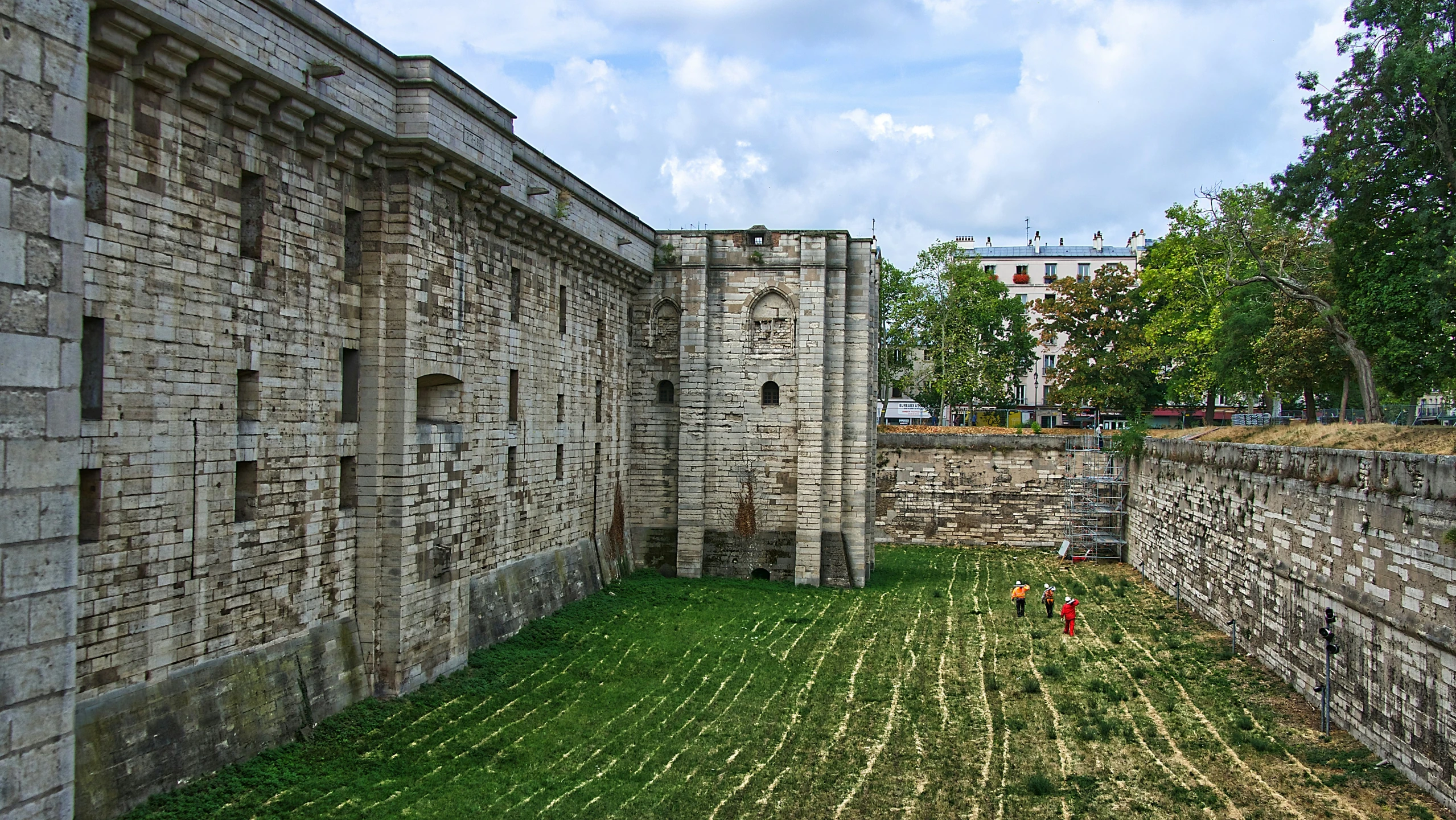 an ancient building with grass inside of it