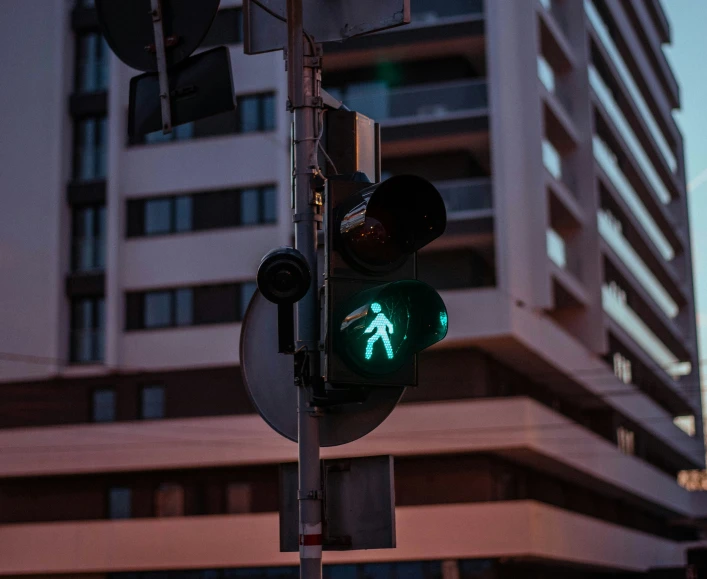there is a green sign with a man underneath
