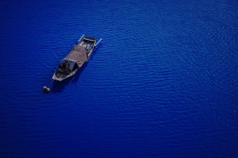 an overhead view of a small boat in the water
