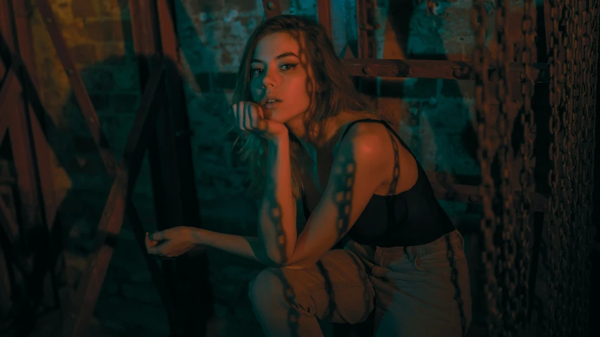 a woman holding onto a piece of furniture in an abandoned building