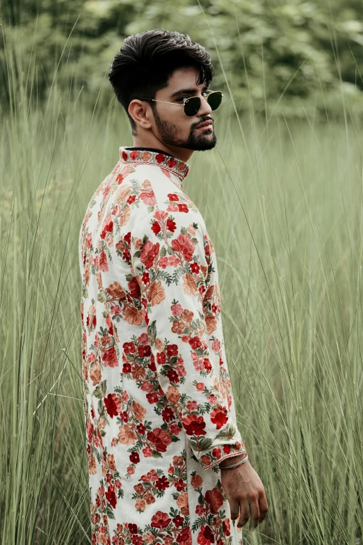 a man in floral shirt looking off to the side