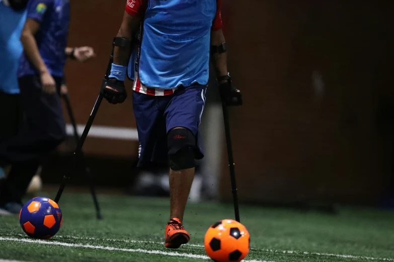 a couple of men on the field with some balls