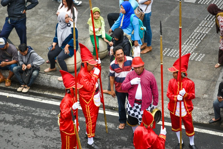 several people in costume are standing near a curb