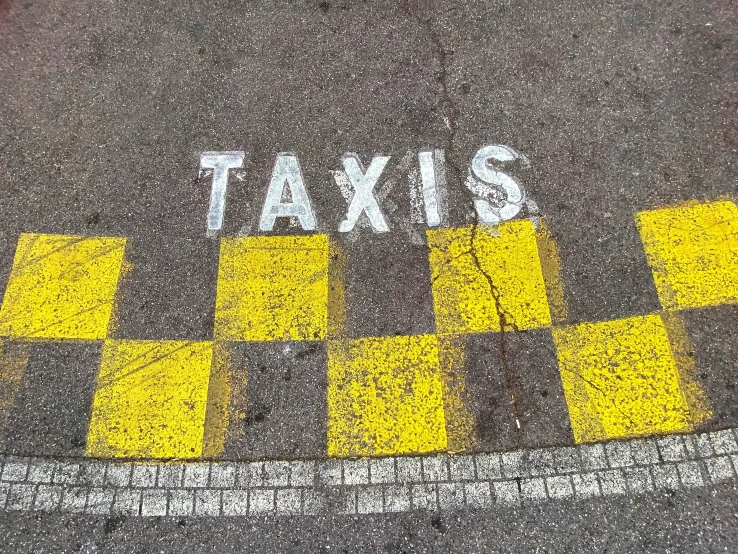 taxi crossing lines are painted yellow and white on the pavement