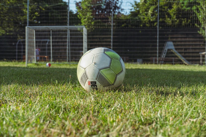 a soccer ball sitting in the middle of a field