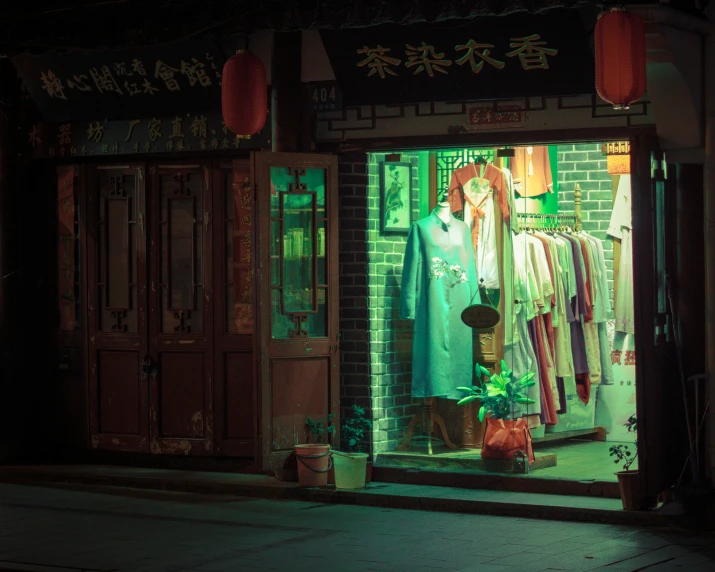 a man in dark clothes stands outside a clothing store