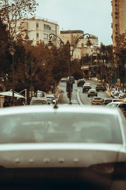 a man in black is walking along the side of the street