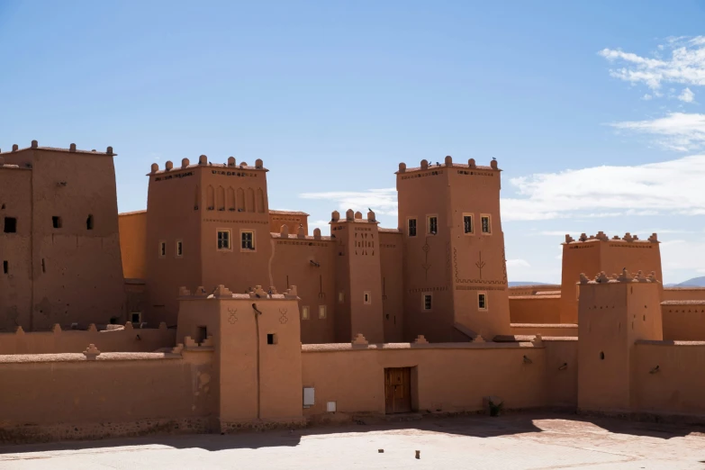 an adobe - style city with mountains in the background