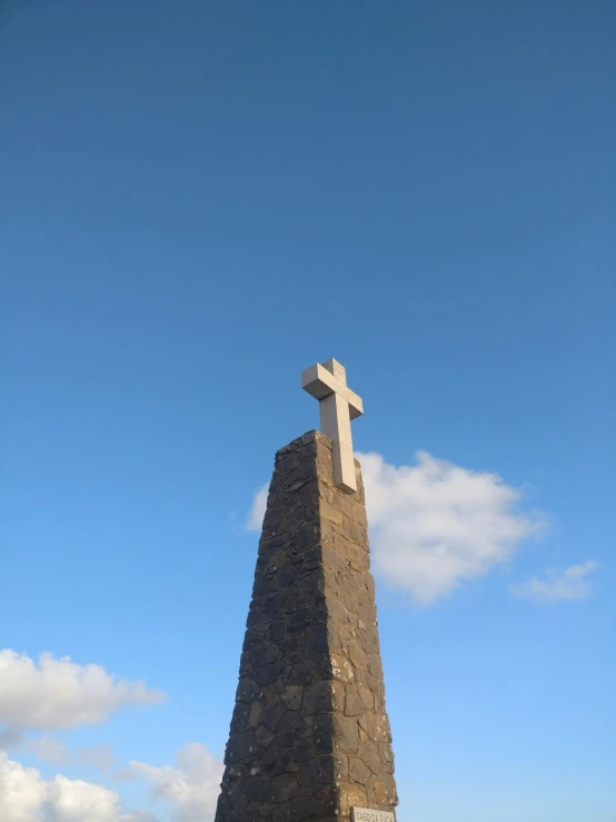 there is a very large statue with a cross at the top