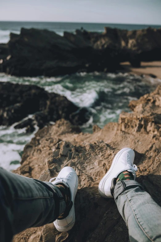 a person standing on a rock overlooking the ocean