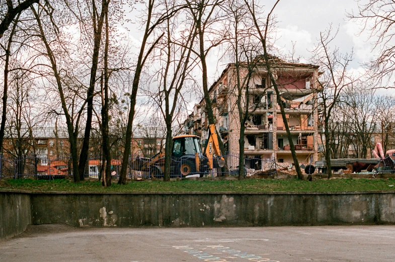 old building with trees and dirt surrounding