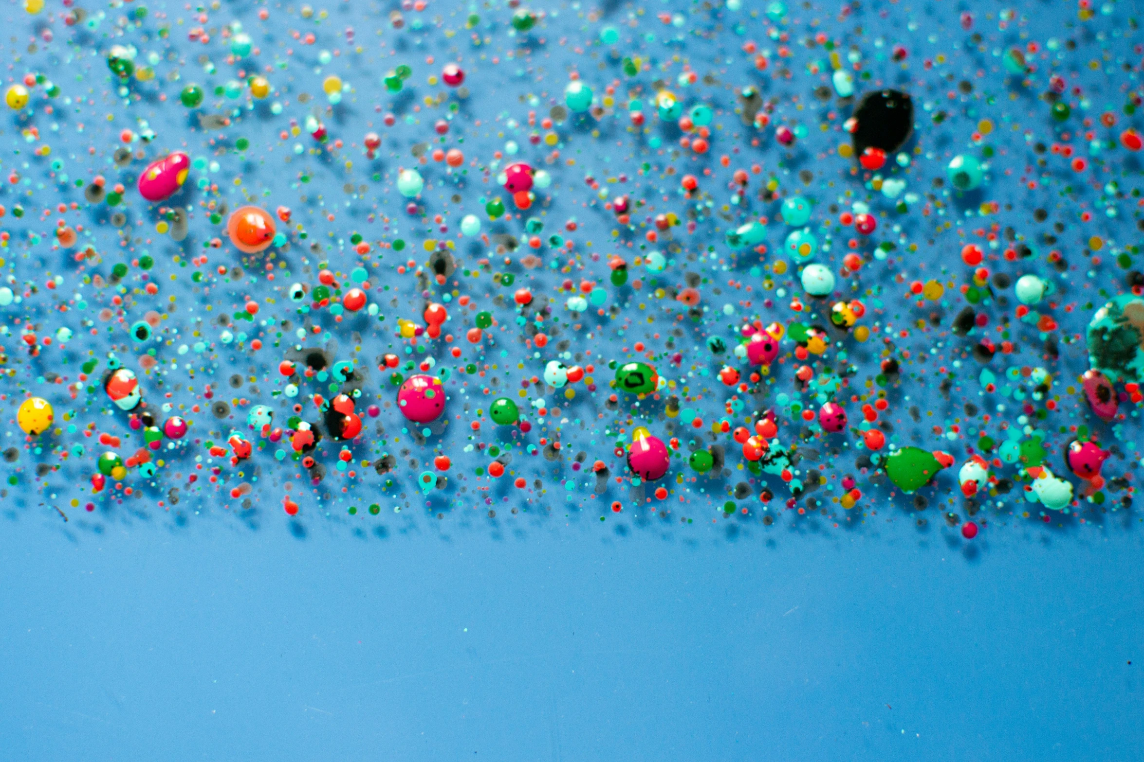 some bright colored confetti with little green and yellow and pink ones