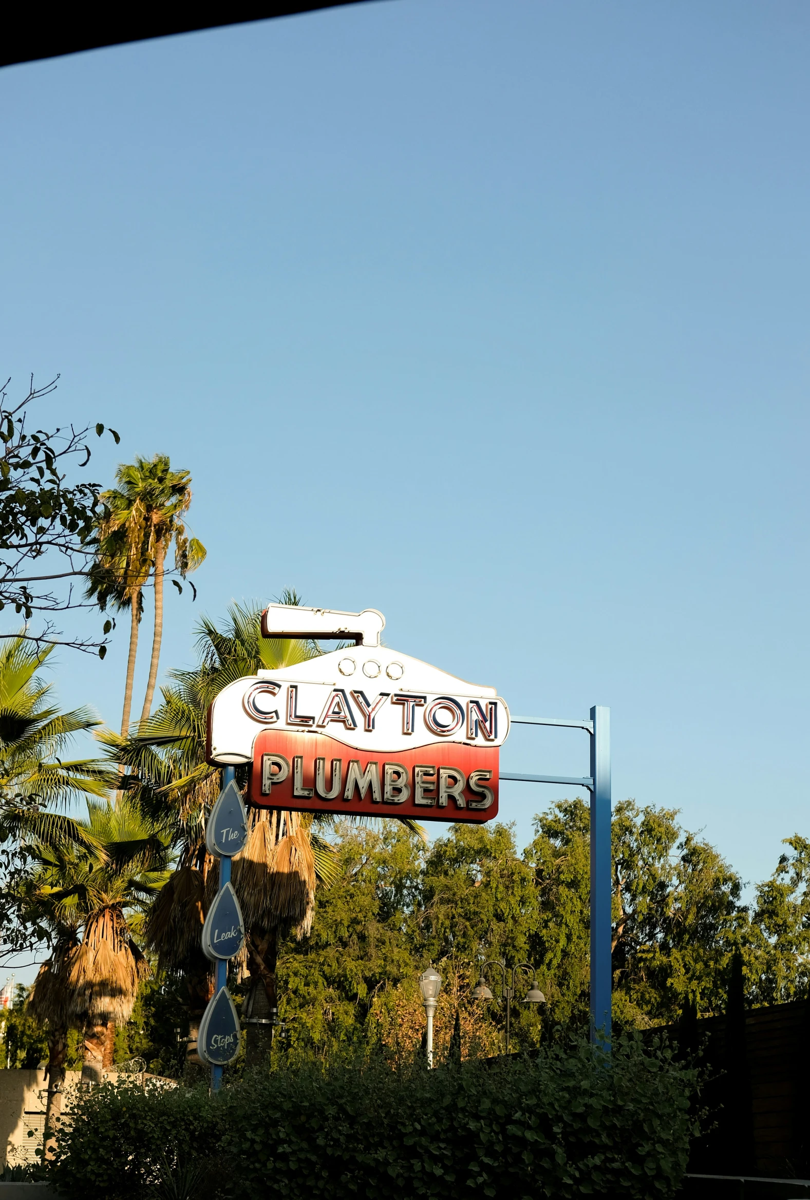 a restaurant sign under a clear blue sky