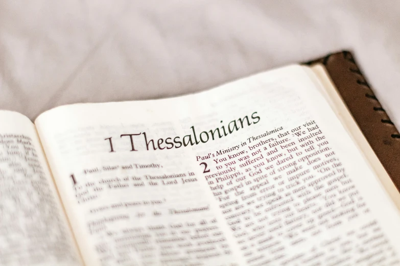 a open book with the word thessadonians printed on it