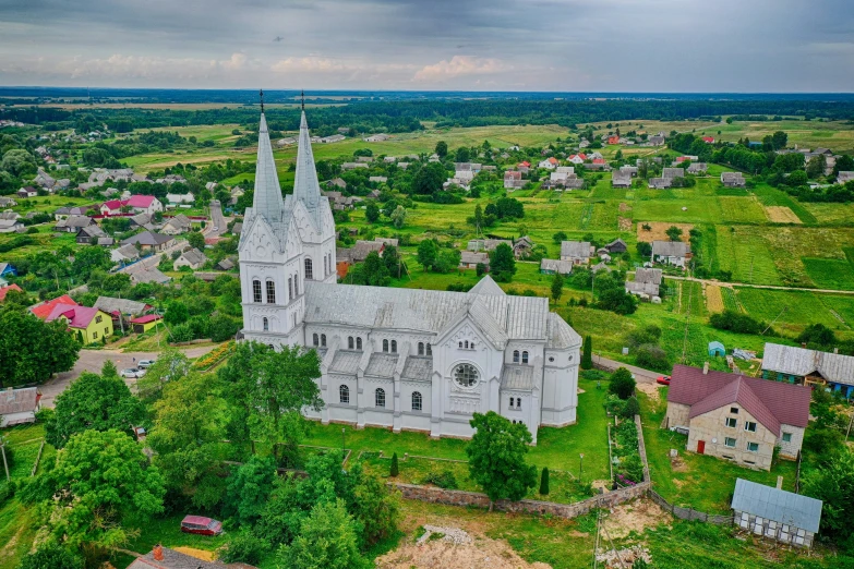 an aerial po of a beautiful cathedral near several houses