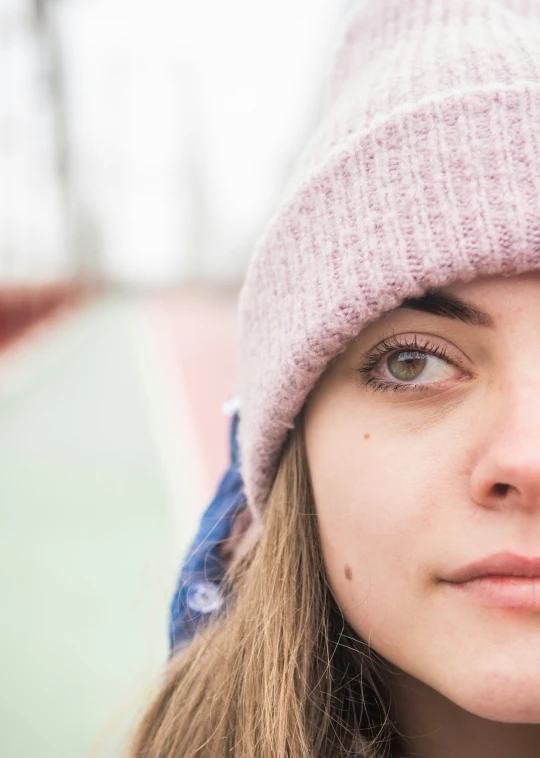 woman wearing purple hat close up on an outdoor area