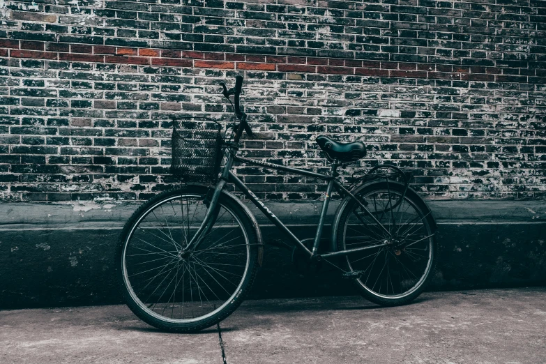 a bike parked against a brick wall