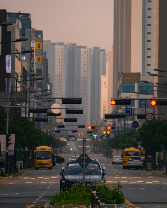 a street filled with traffic next to tall buildings