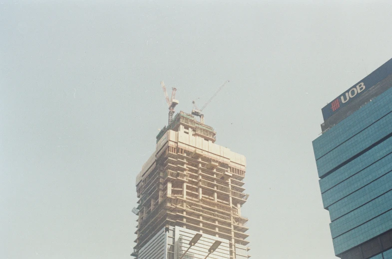 a tall building under construction in the daytime