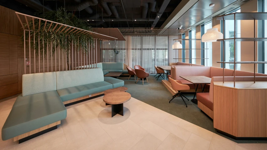 a lobby with couches, tables and chairs in it