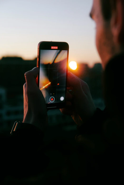 a person holding up a phone with their phone