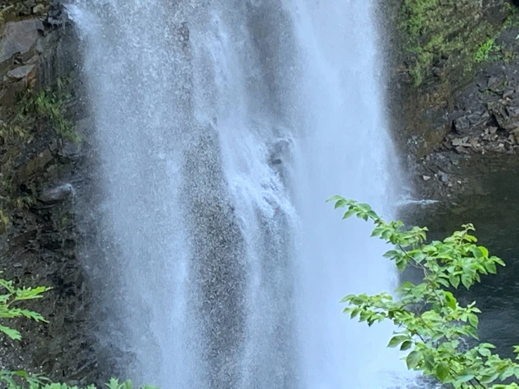 a large waterfall flows into the water