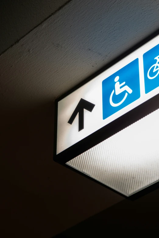 a sign is illuminated on an outside ceiling