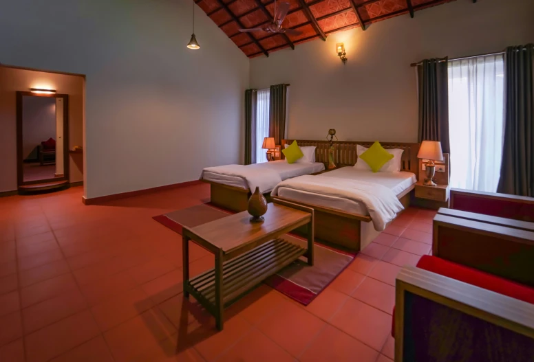 an empty el room with two twin beds and red tiled floor