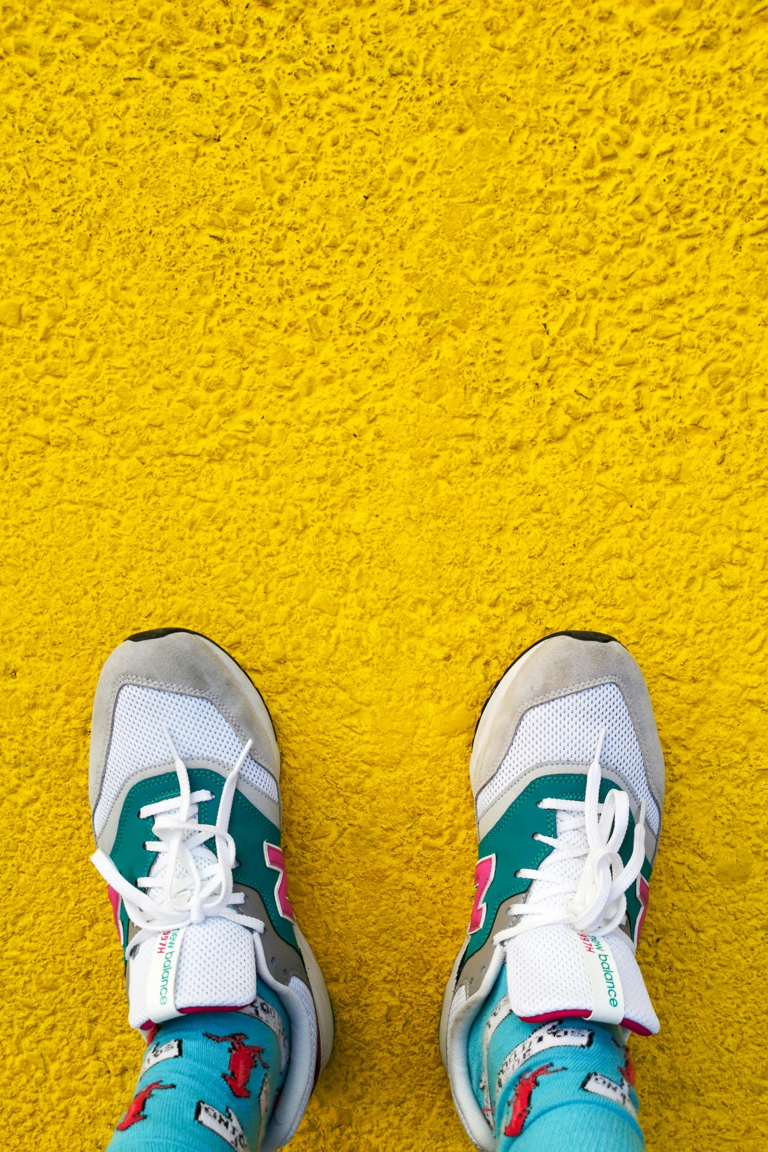 feet in white and blue shoes on yellow carpet