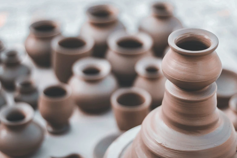 lots of clay pots are sitting on the table