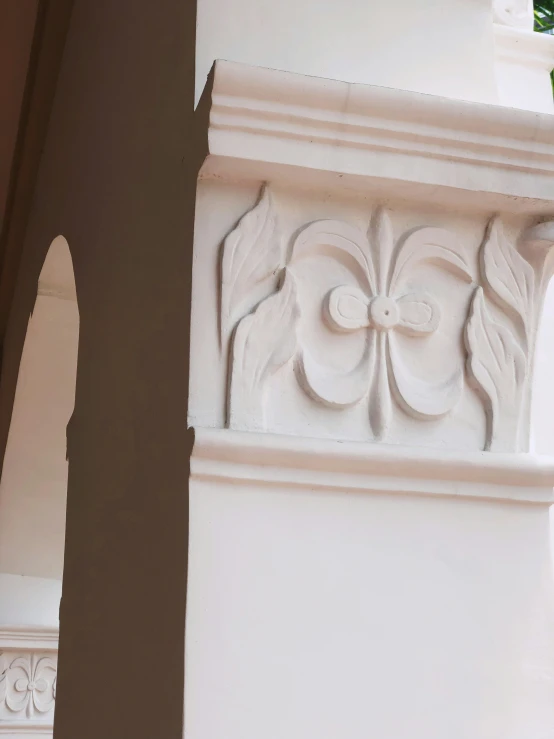 an old pillar with flowers carved into it