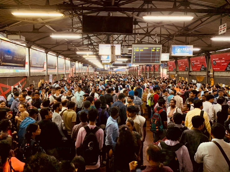 there is a large crowd waiting at the train station