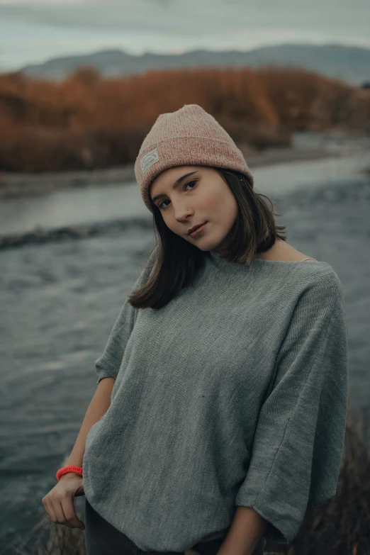 a woman wearing a hat looking at the camera