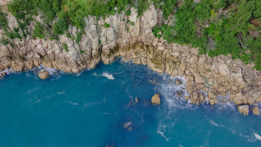 a large rock formation with water below it