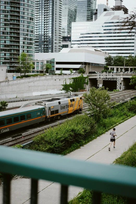 a woman with a backpack is walking near a train