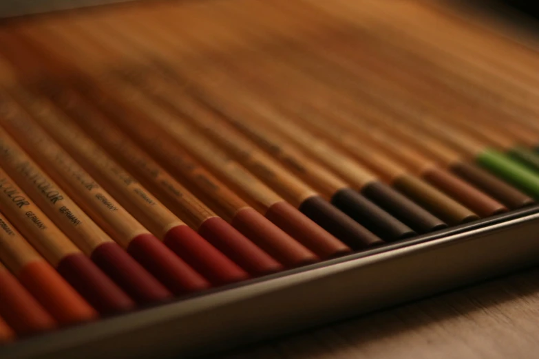 many different pencils lined up in a row