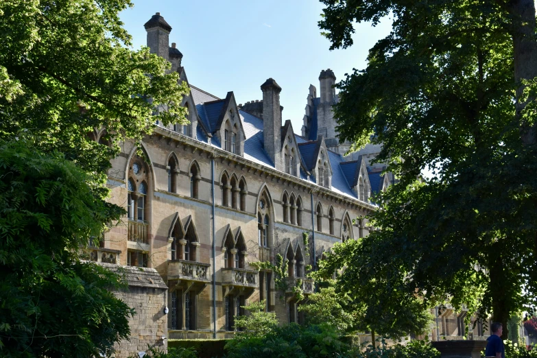 a big building with an outside patio and grass in front