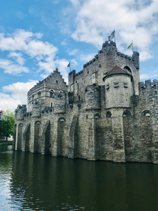 an ancient castle stands on the edge of water